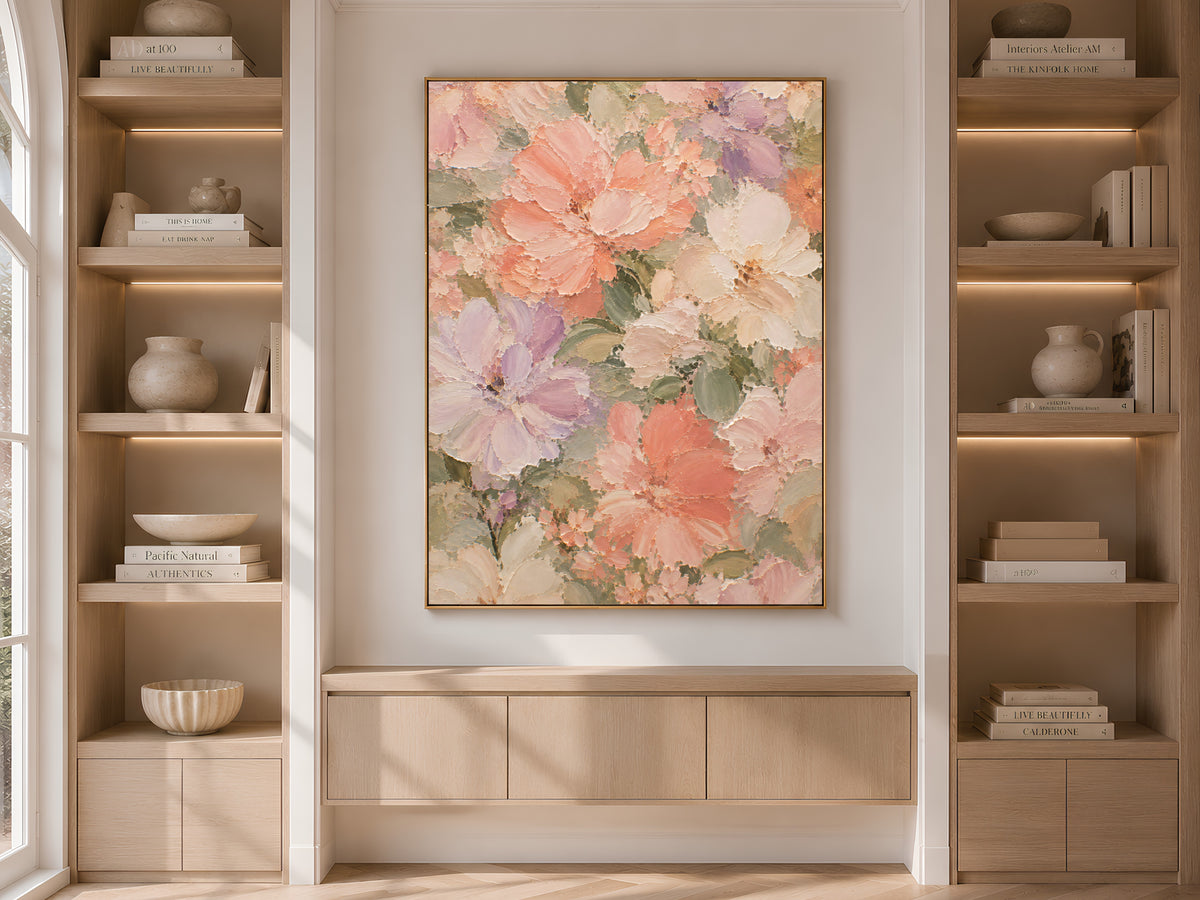 Pastel dahlia peony wall art print displayed above a built-in cabinet between wooden bookshelves