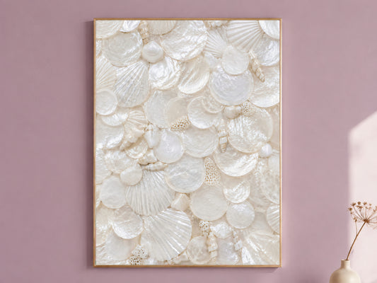 Mother of pearl wall art in a thin gold frame hanging on a dusty mauve wall, styled with a small dried flower vase.
