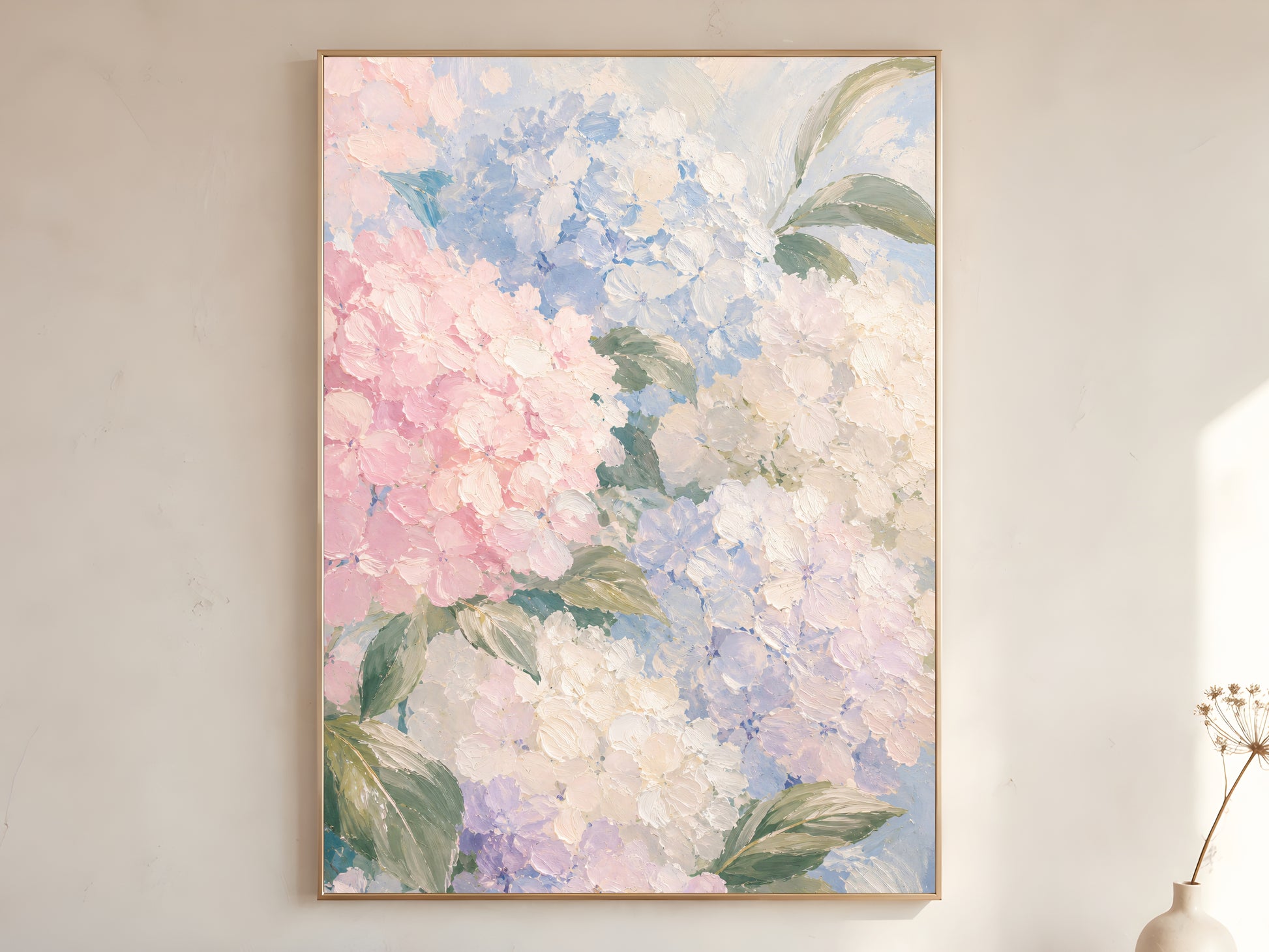 
Pastel hydrangea oil painting in gold frame leaning against a white wall with dried florals