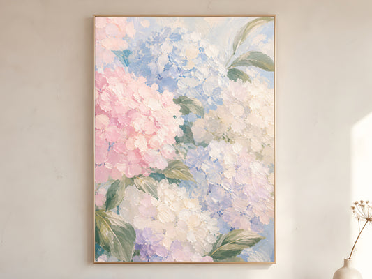 
Pastel hydrangea oil painting in gold frame leaning against a white wall with dried florals