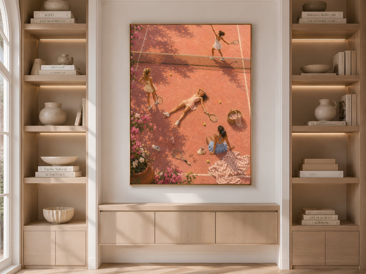 Pink tennis court print framed and displayed in built-in wood shelving with books and decor