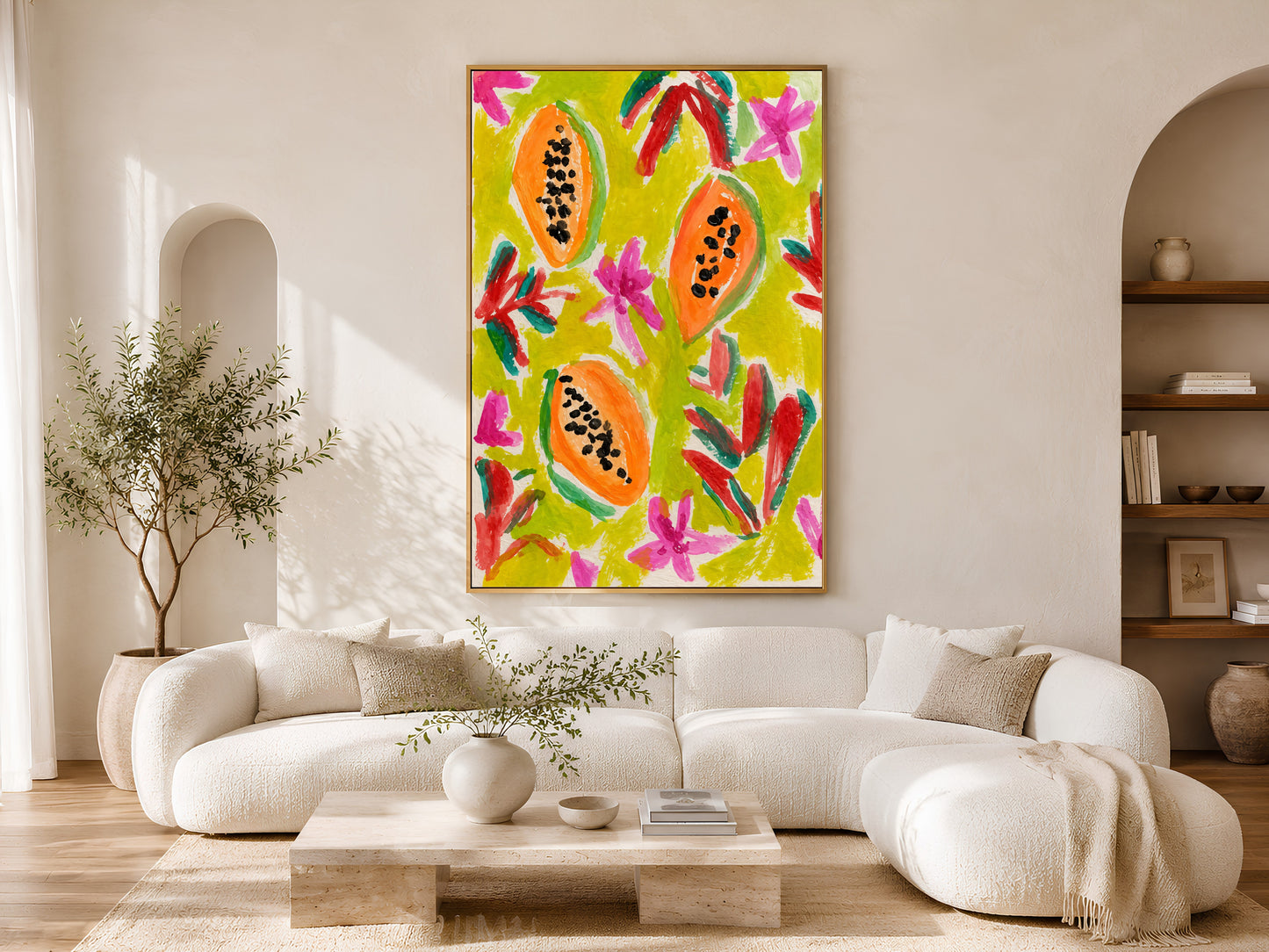 Colorful papaya wall art in a gold frame displayed above a curved white sofa in a bright Scandinavian living room with warm wood coffee table and natural light
