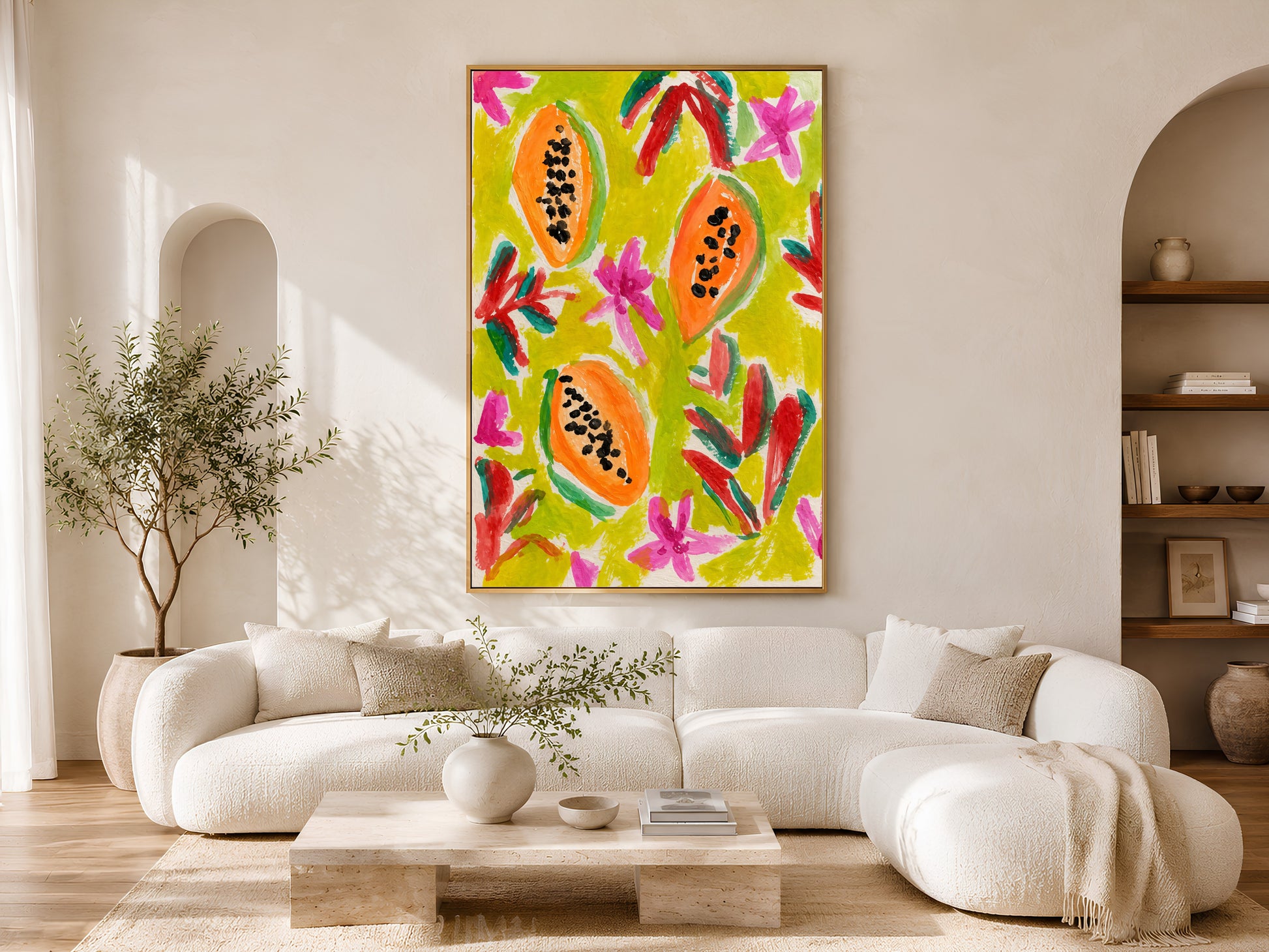 Colorful papaya wall art in a gold frame displayed above a curved white sofa in a bright Scandinavian living room with warm wood coffee table and natural light
