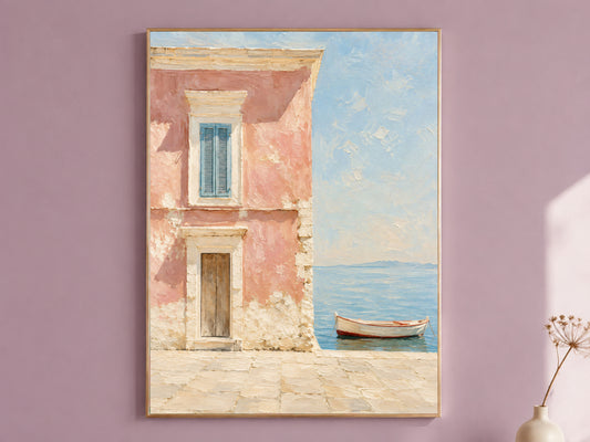 Pink Amalfi Coast wall art print in a thin gold frame, mounted on a dusty mauve wall, showing a Mediterranean pink house facade with blue shutters and a wooden boat