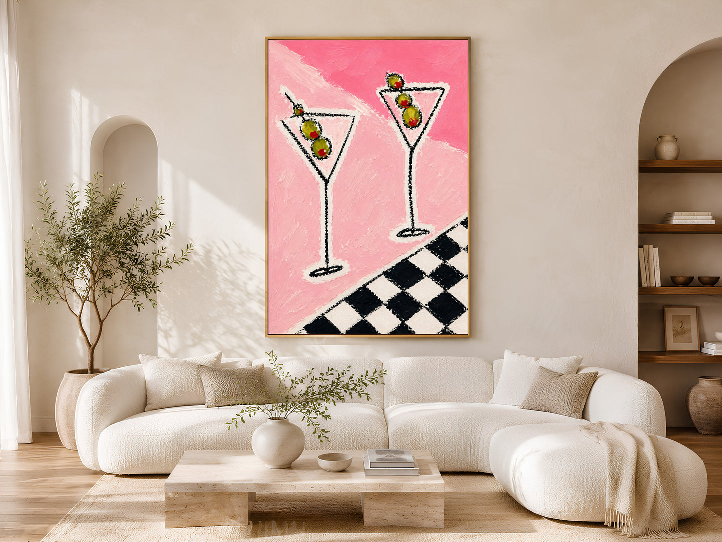 Framed impasto martini print on warm white wall in minimal living room with curved cream sofa and arch window
