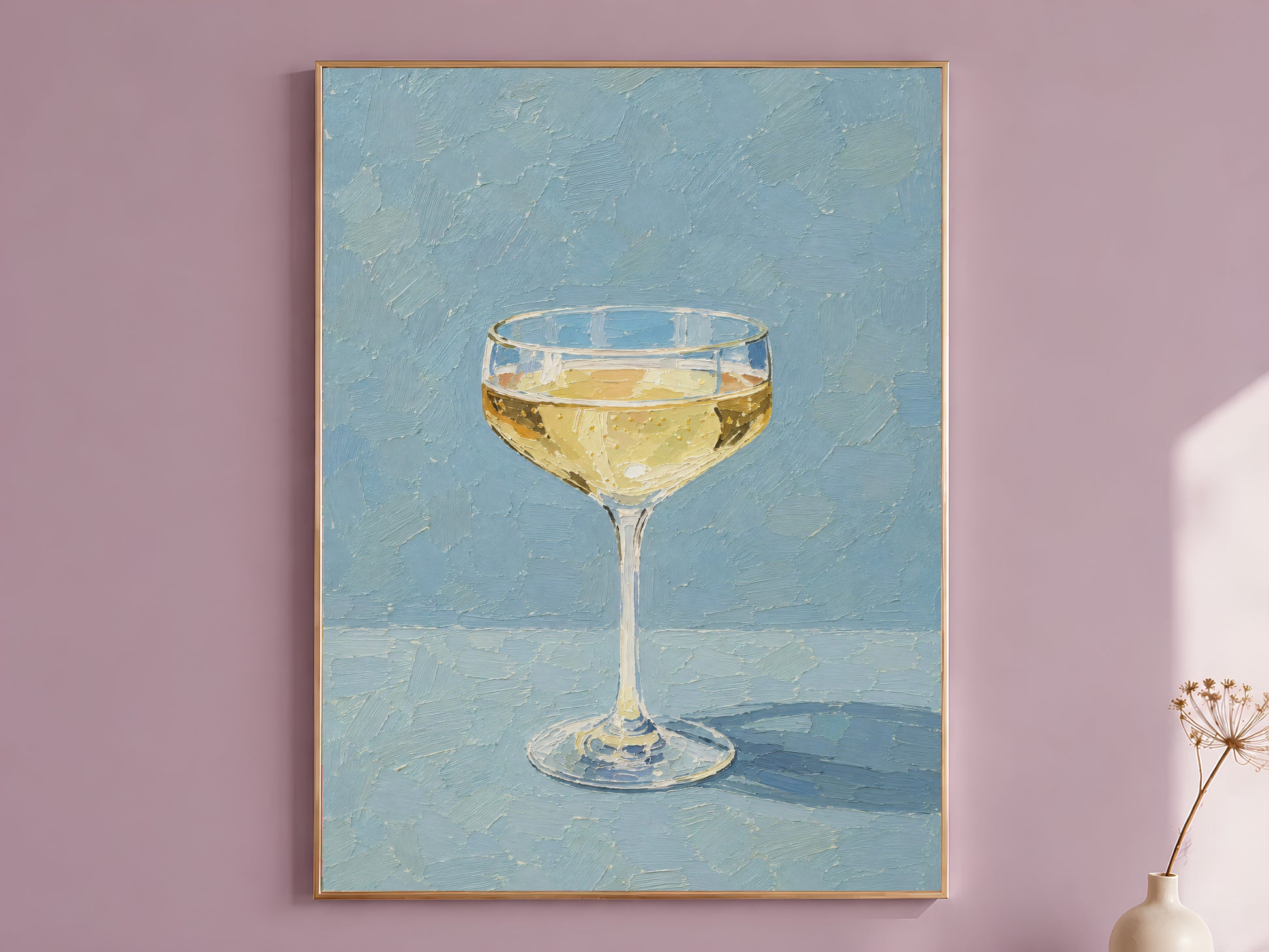 Champagne coupe wall art in gold frame on a mauve wall, dusty blue background
