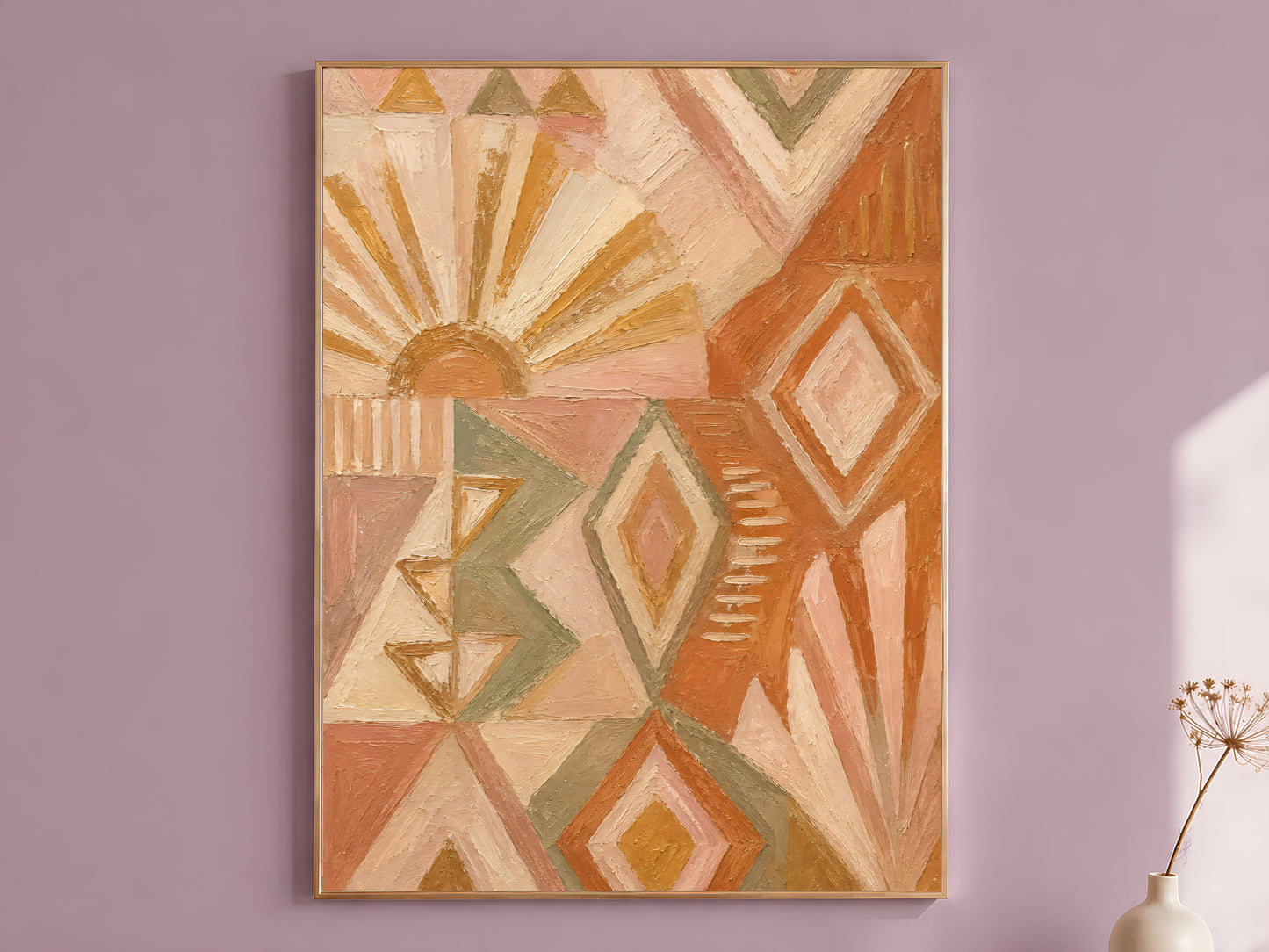 Boho geometric wall art print framed on a mauve wall, terracotta sunburst and sage diamond pattern impasto oil painting style, with a small vase of dried flowers
