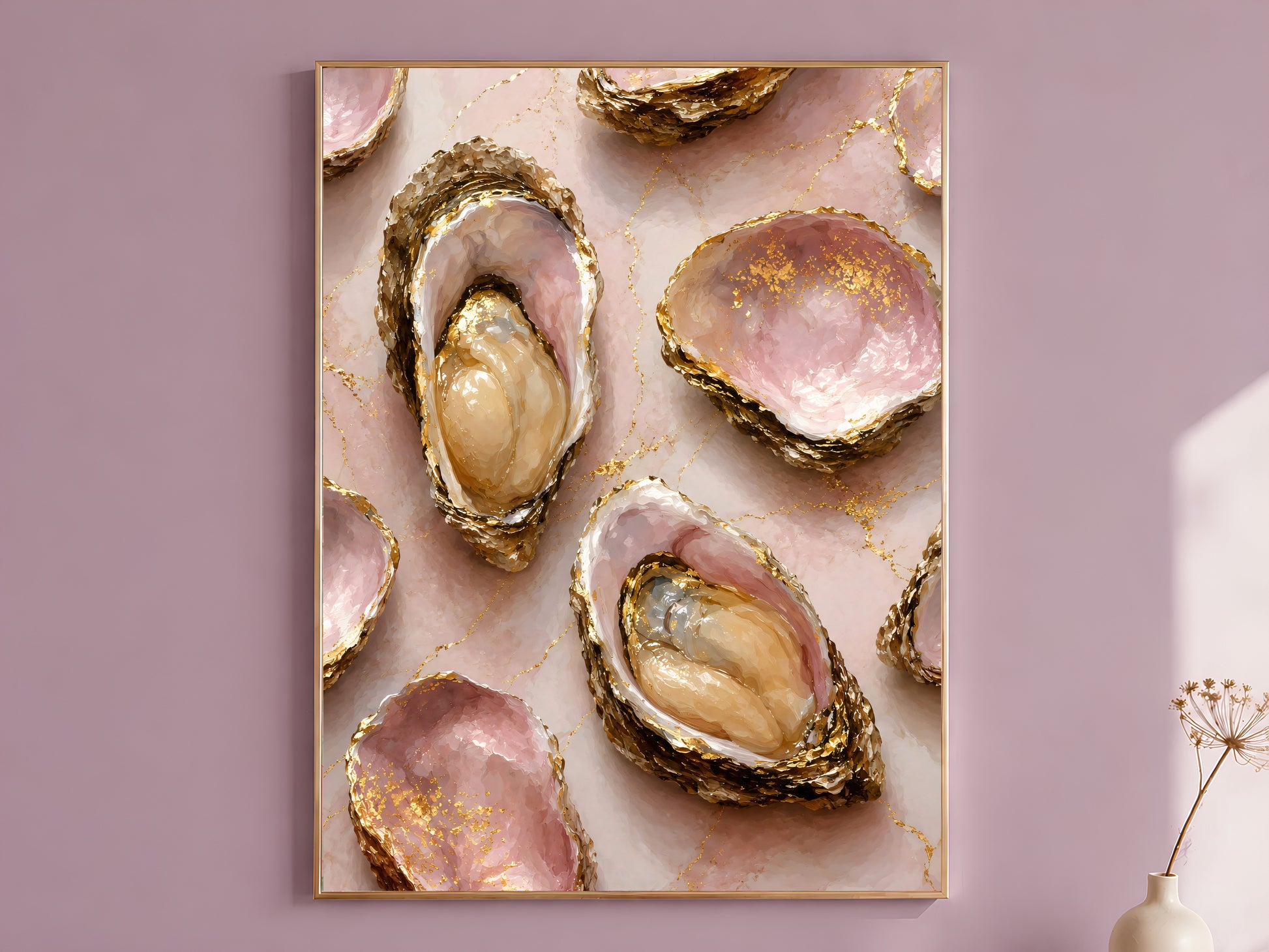 Pink oyster shell wall art print in a gold frame hanging on a dusty mauve wall beside a vase of dried flowers.
