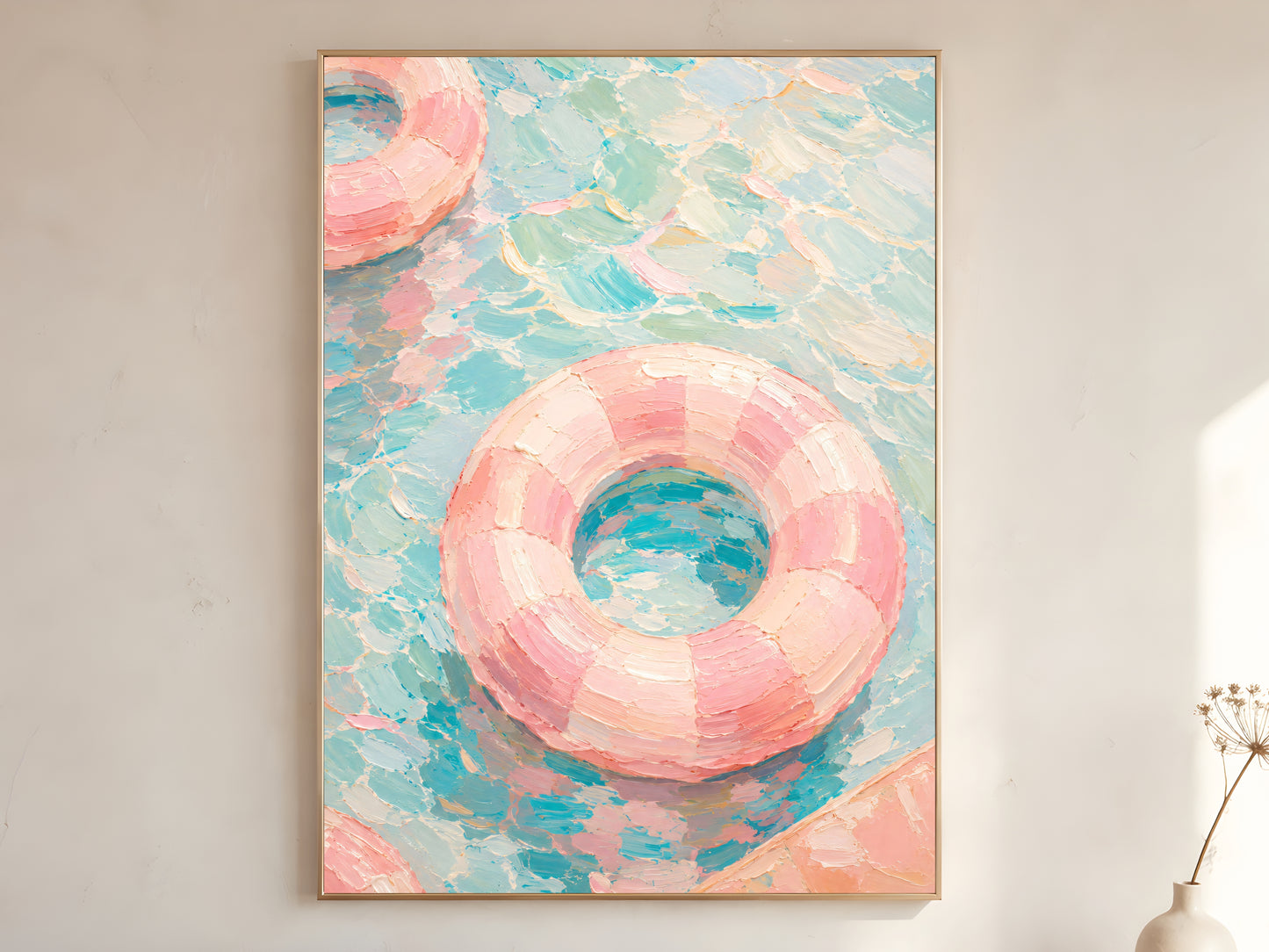 Pink pool float oil painting in gold frame leaning against a white wall with dried florals