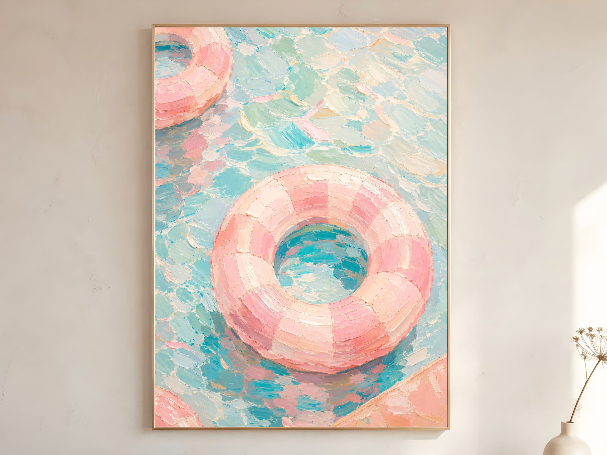 Pink pool float oil painting in gold frame leaning against a white wall with dried florals