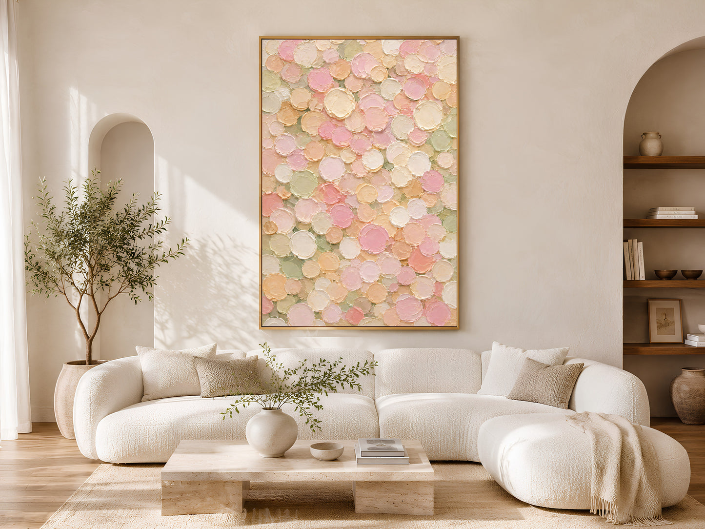 Pastel abstract dots wall art print framed above a cream sofa in a sunlit living room.
