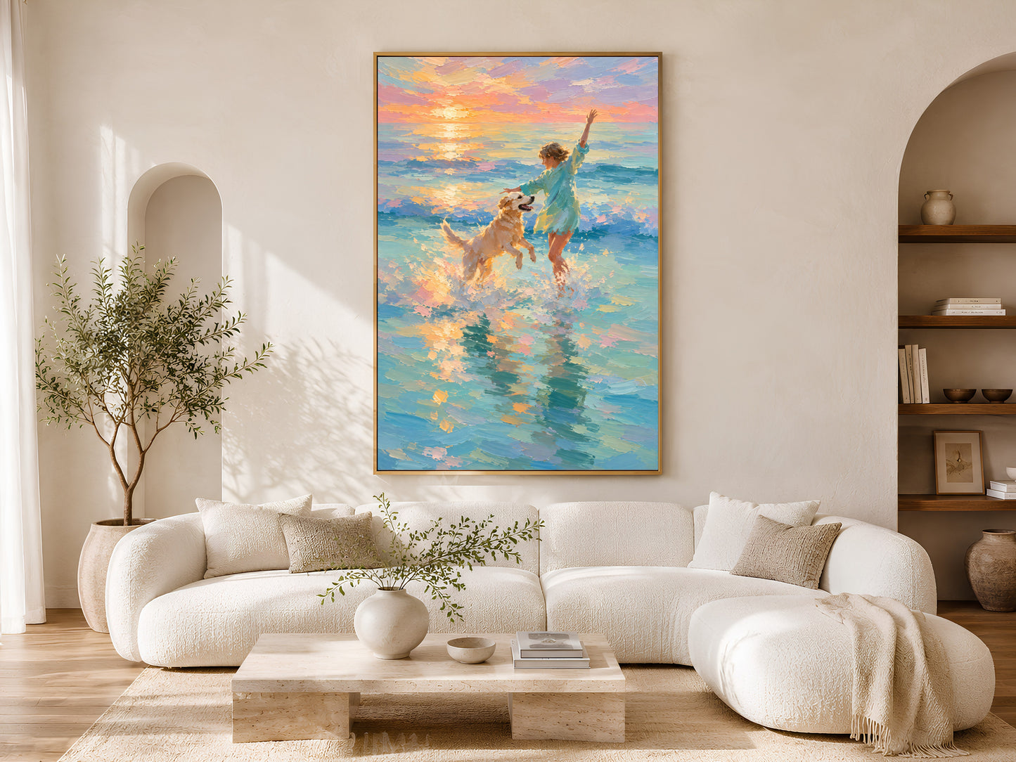 Girl and golden retriever beach sunset impasto painting in a gold frame above a curved white sofa in a bright Scandinavian living room with olive tree, neutral cushions, and warm natural light

