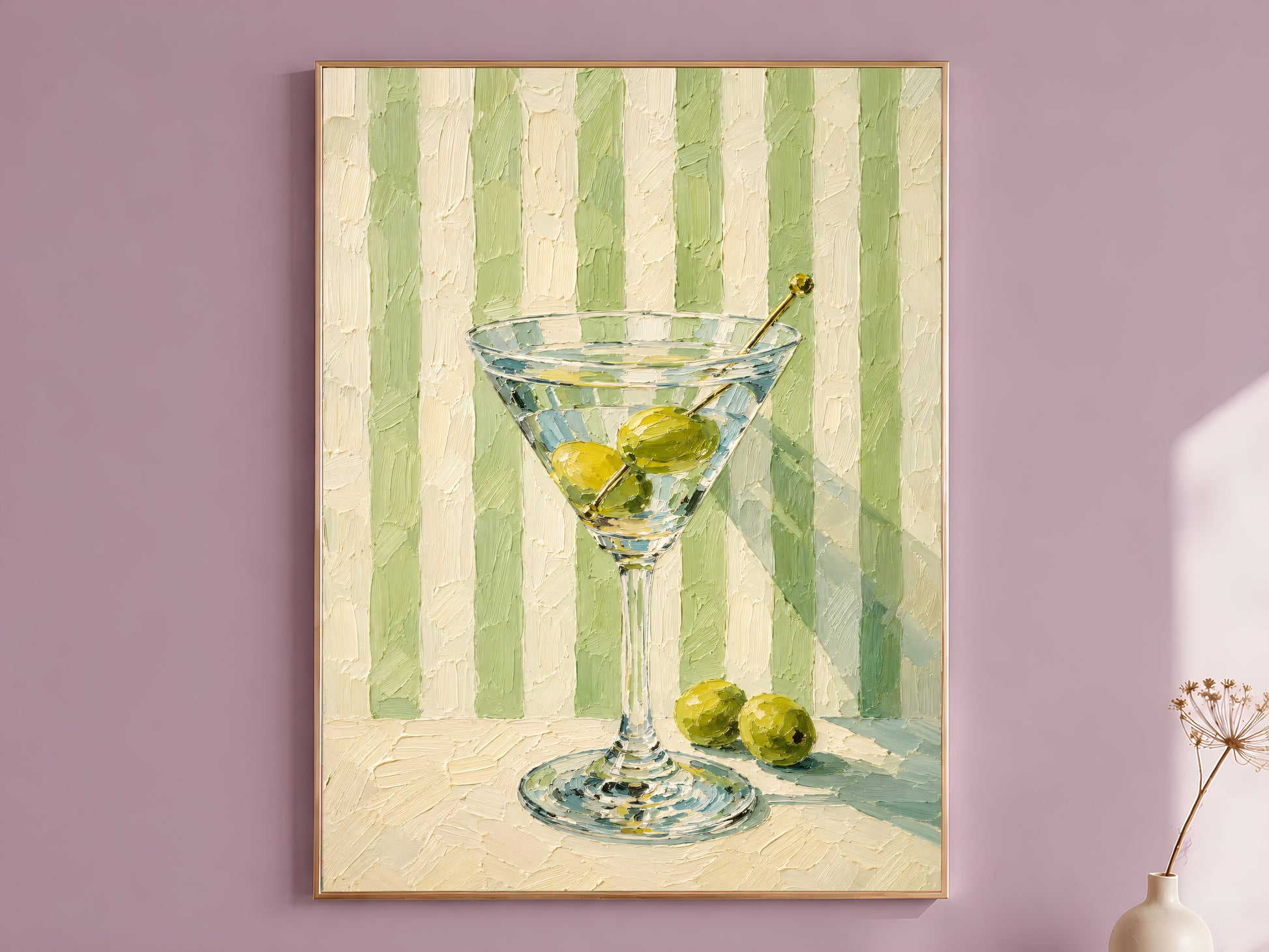 Martini glass wall art in gold frame on a mauve wall, green striped background
