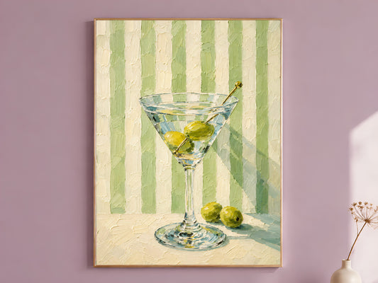 Martini glass wall art in gold frame on a mauve wall, green striped background
