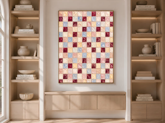 Framed pink blue mosaic print displayed on a built-in bookshelf with books and decor