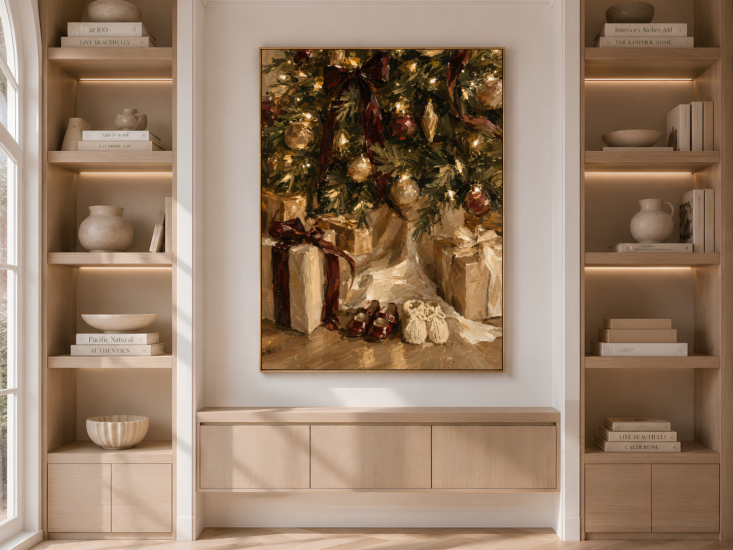 Built-in shelving nook with the Christmas morning print centered above a low cabinet, flanked by books and ceramics