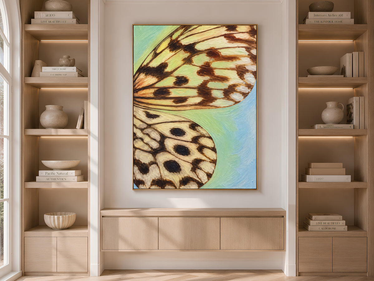 Teal gradient butterfly wing print framed on built-in shelving in a warm neutral living room
