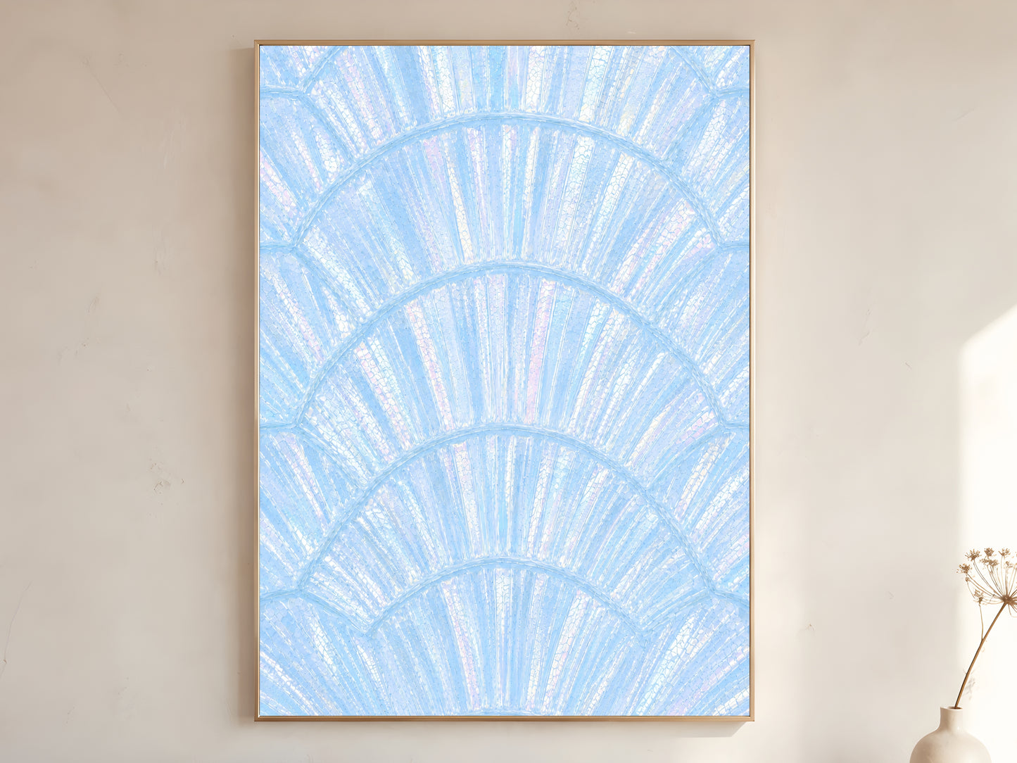 Blue iridescent capiz shell print in gold frame leaning against a white wall with dried florals
