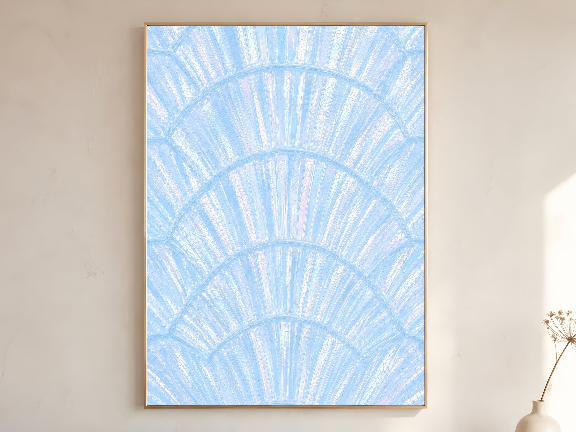 Blue iridescent capiz shell print in gold frame leaning against a white wall with dried florals