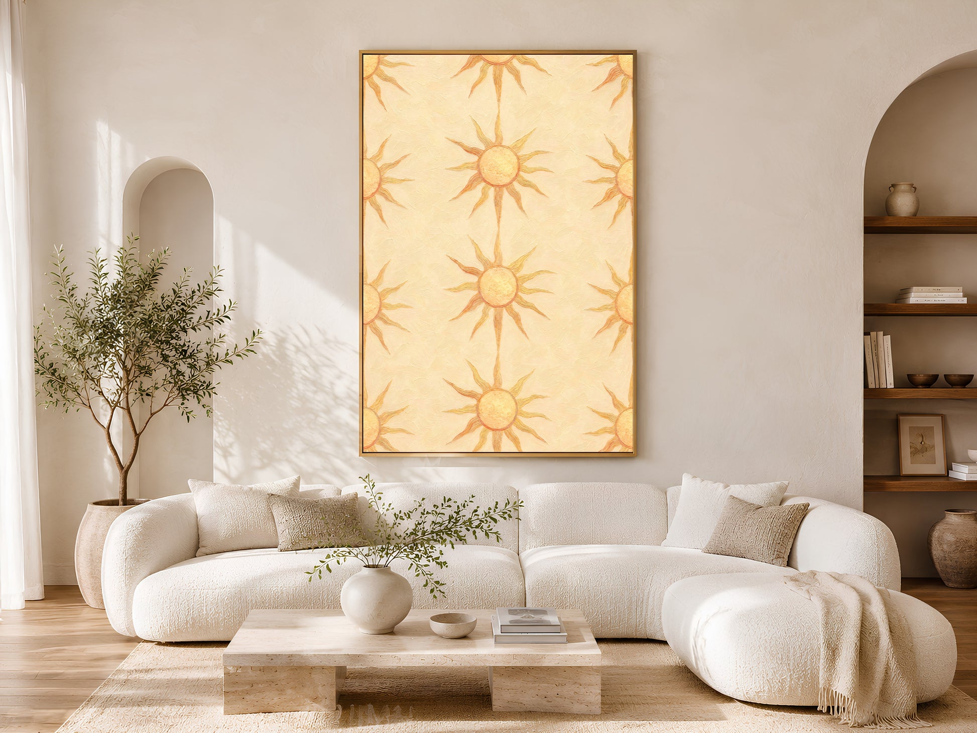 Boho sun wall art framed on a wall in an arched alcove living room with a cream boucle sectional sofa and jute rug.
