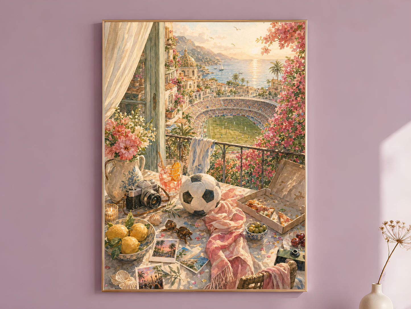 Framed sunset balcony wall art print in a thin gold frame, hanging on a dusty mauve wall beside a curtain and dried flower stem.
