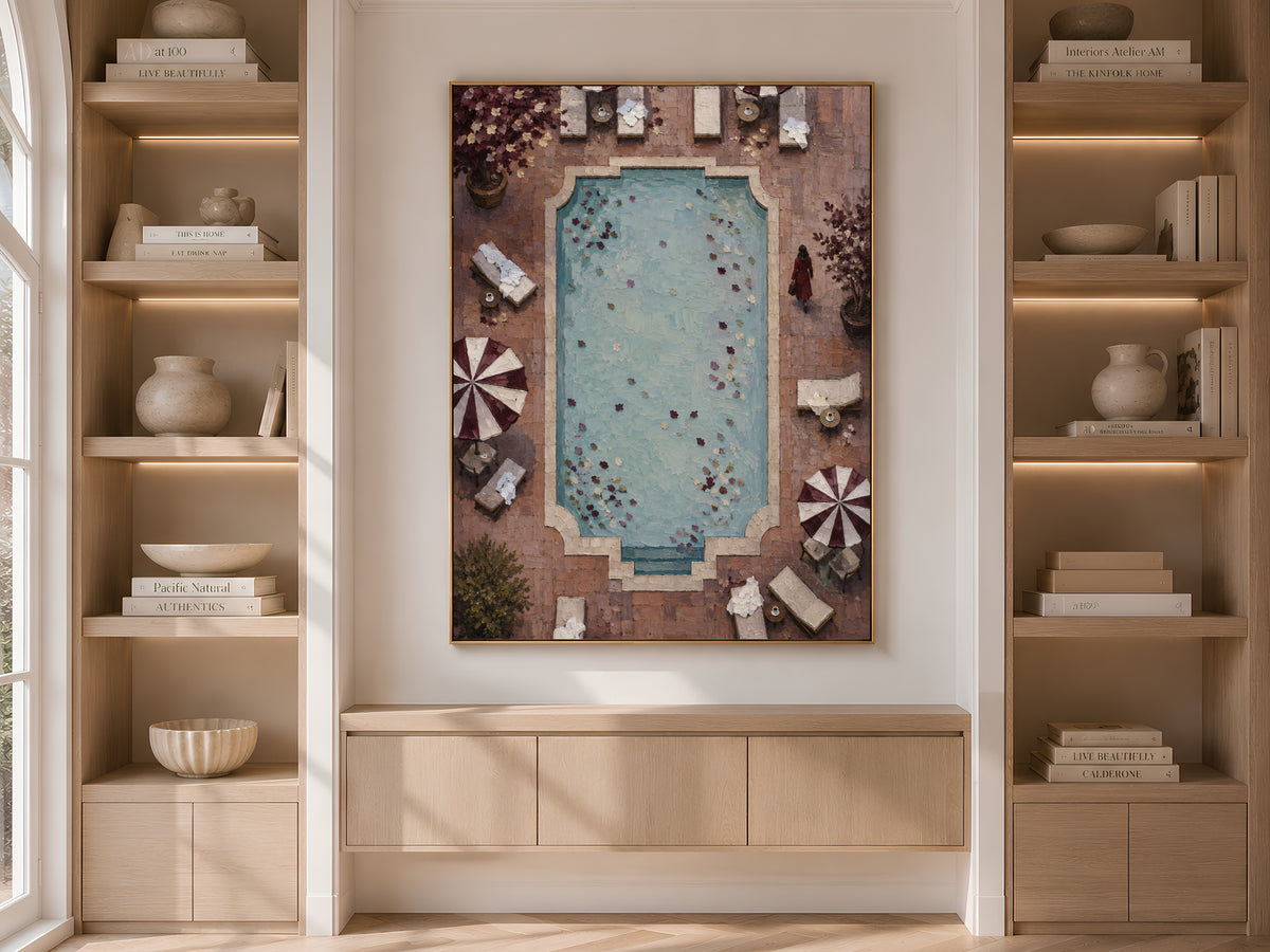 Aerial pool and umbrella art framed in wood built-in bookshelf nook