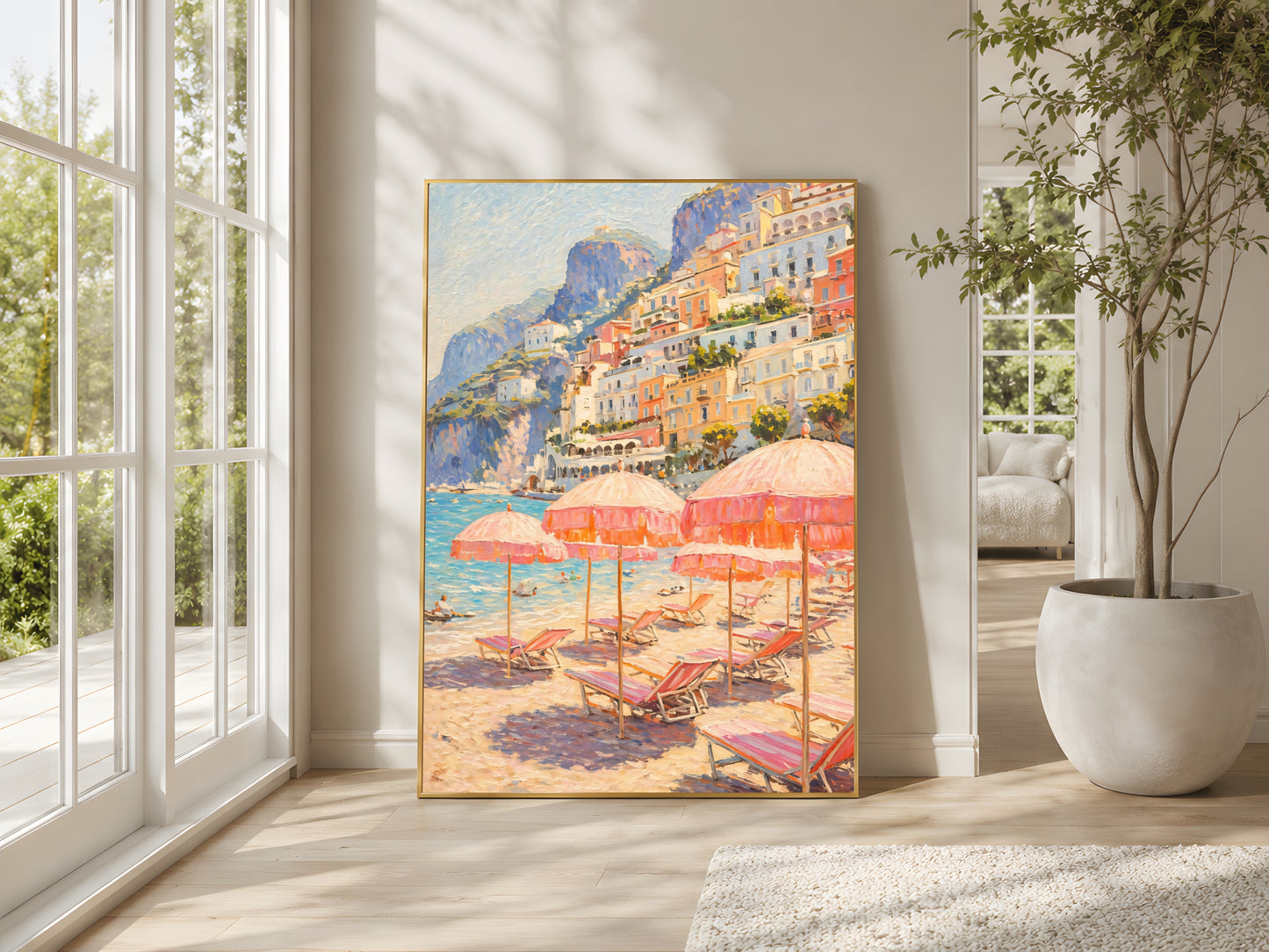 Positano beach club impasto wall art print in gold frame leaning against wall in bright minimalist living room with floor-to-ceiling windows, large indoor plant and natural light