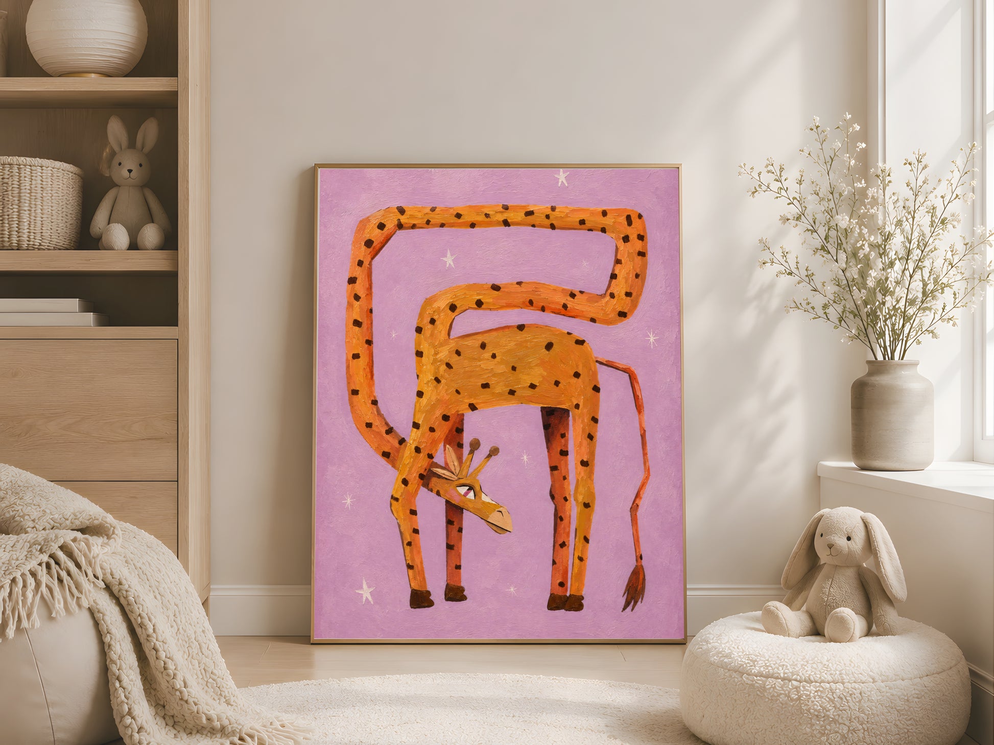 Whimsical orange giraffe wall art in a gold frame displayed in a bright neutral kids room with a teepee, linen poufs, and a plush bunny beside the bed
