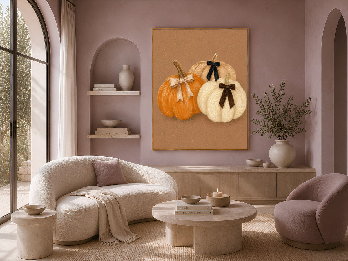 Coquette pumpkin wall art with velvet bows above a boucle living room sofa