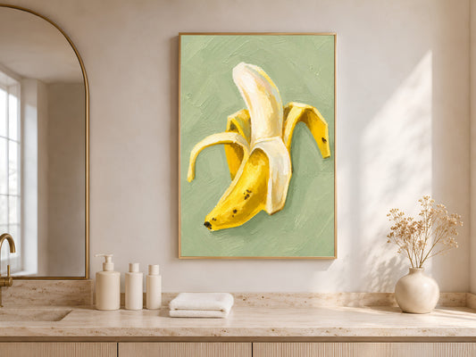Framed banana still life art above kitchen counter with window light, butter yellow wall art print