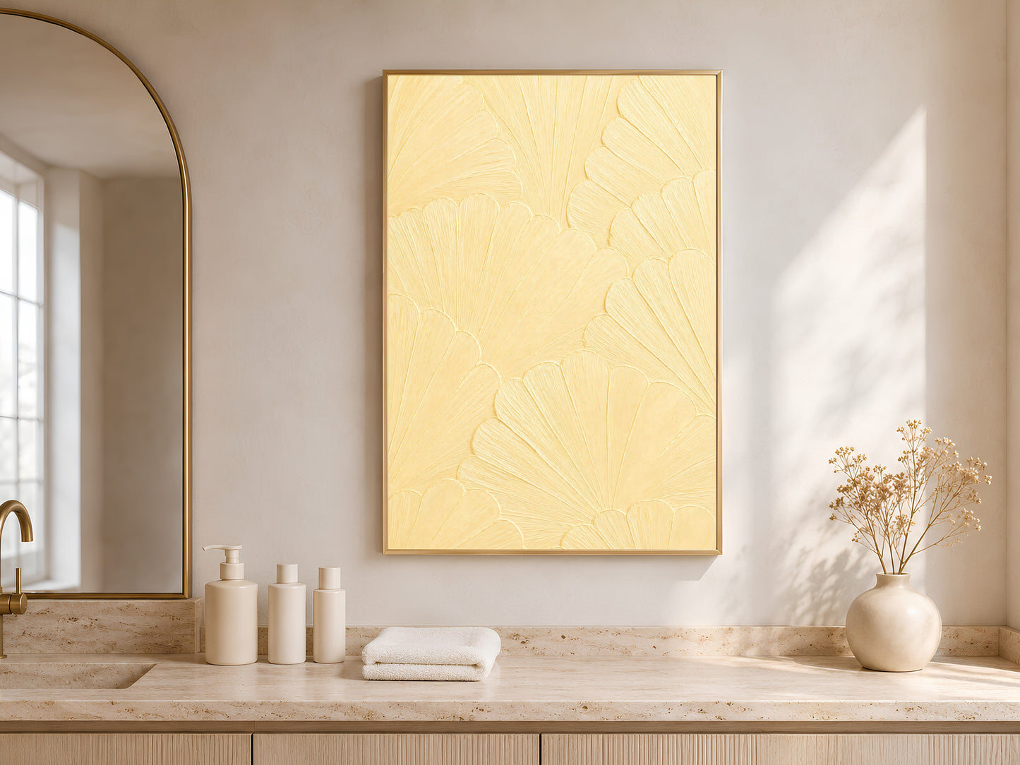Butter yellow wall art displayed above a bathroom vanity with towels and fresh flowers