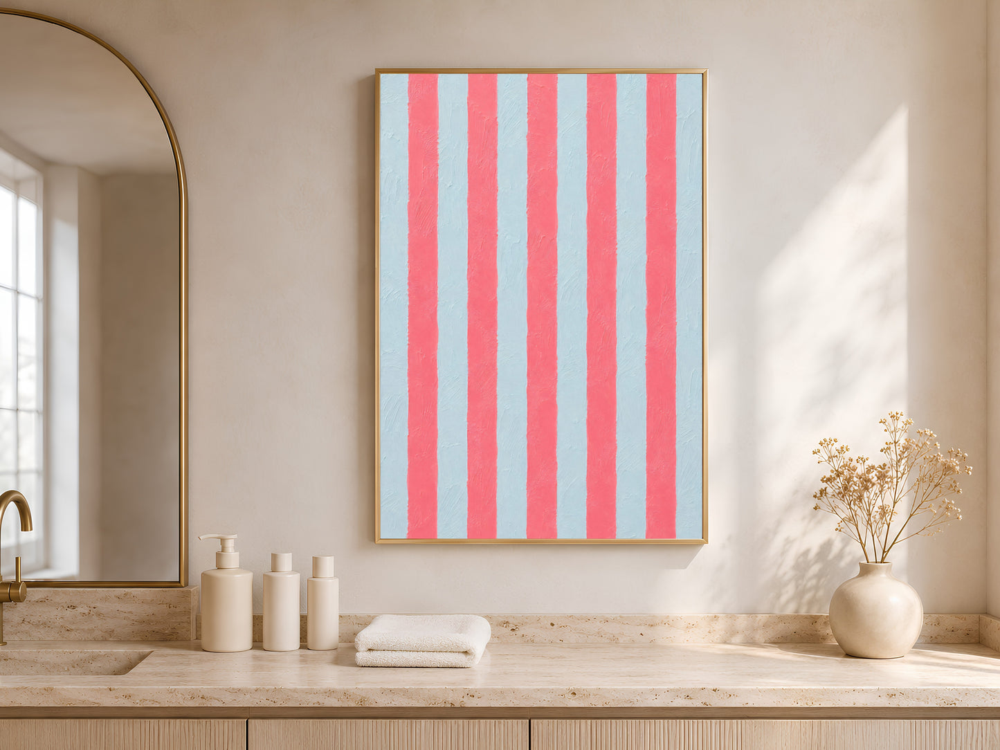 Framed pink blue stripe print above a bathroom vanity with white bottles