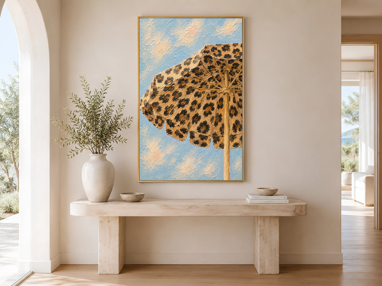 Framed leopard beach umbrella impasto art print in a minimal cream entryway with wooden console table, ceramic vases and soft natural light
