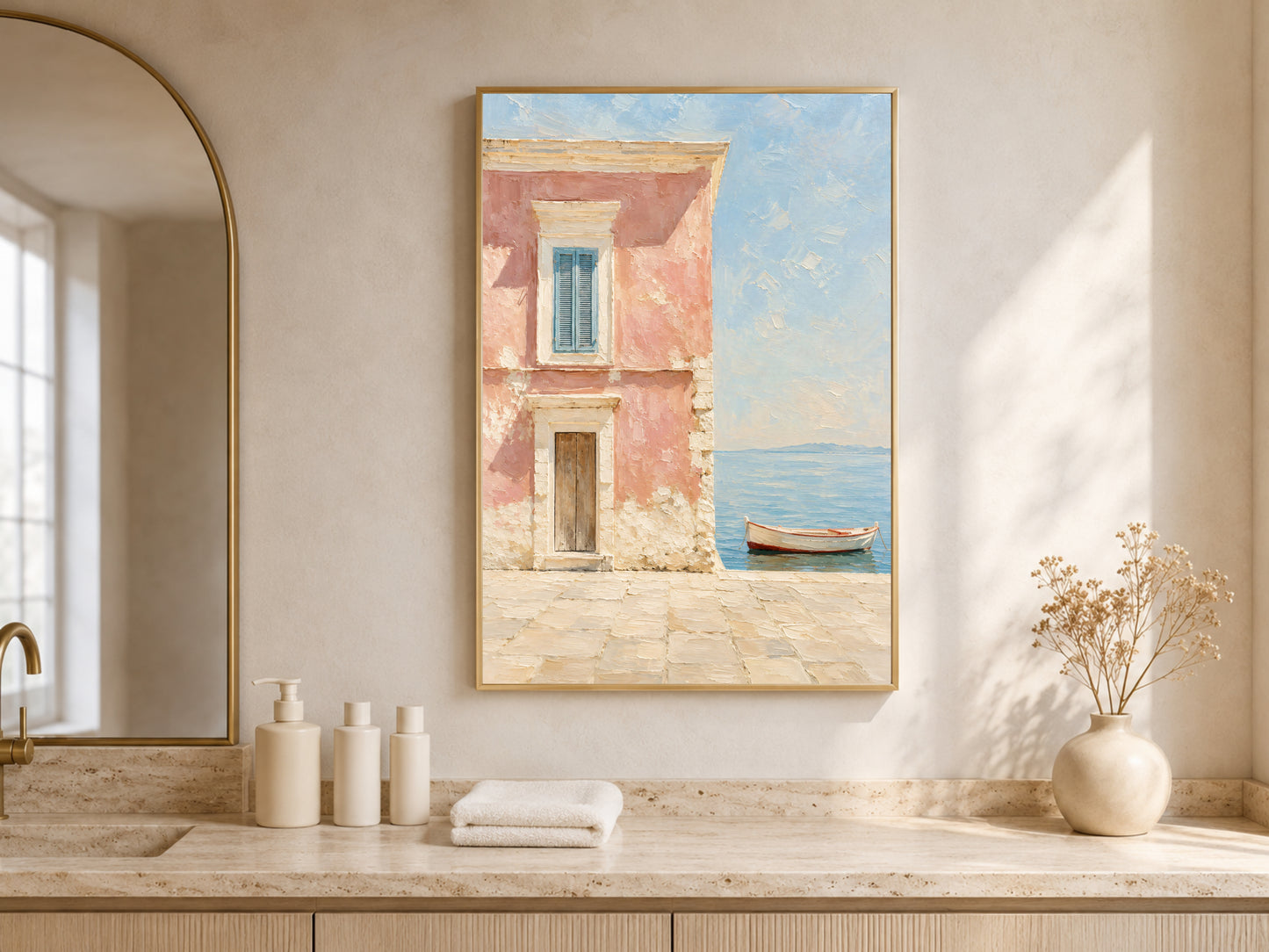 Framed Mediterranean wall art displayed above a bathroom vanity styled with dried florals, in a warm neutral space