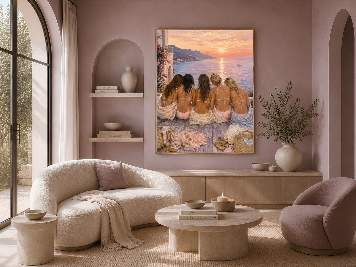 Girls trip sunset print framed on a wall beside a cream sofa and boucle chairs