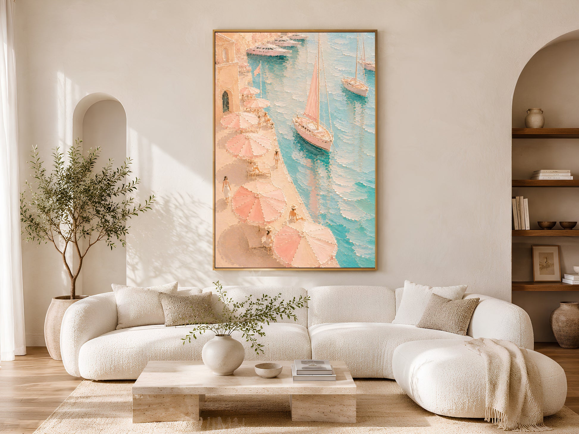 Framed Mediterranean harbor painting print in pink and teal in a warm neutral living room with white curved sofa, olive tree and coffee table
