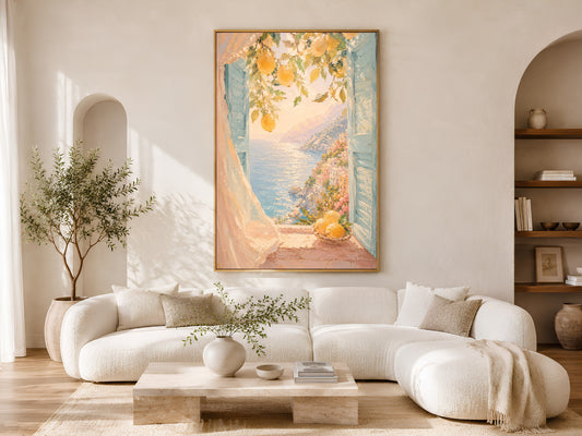 Amalfi Coast lemon print in gold frame above a cream sofa in a bright Mediterranean living room with arched shelving