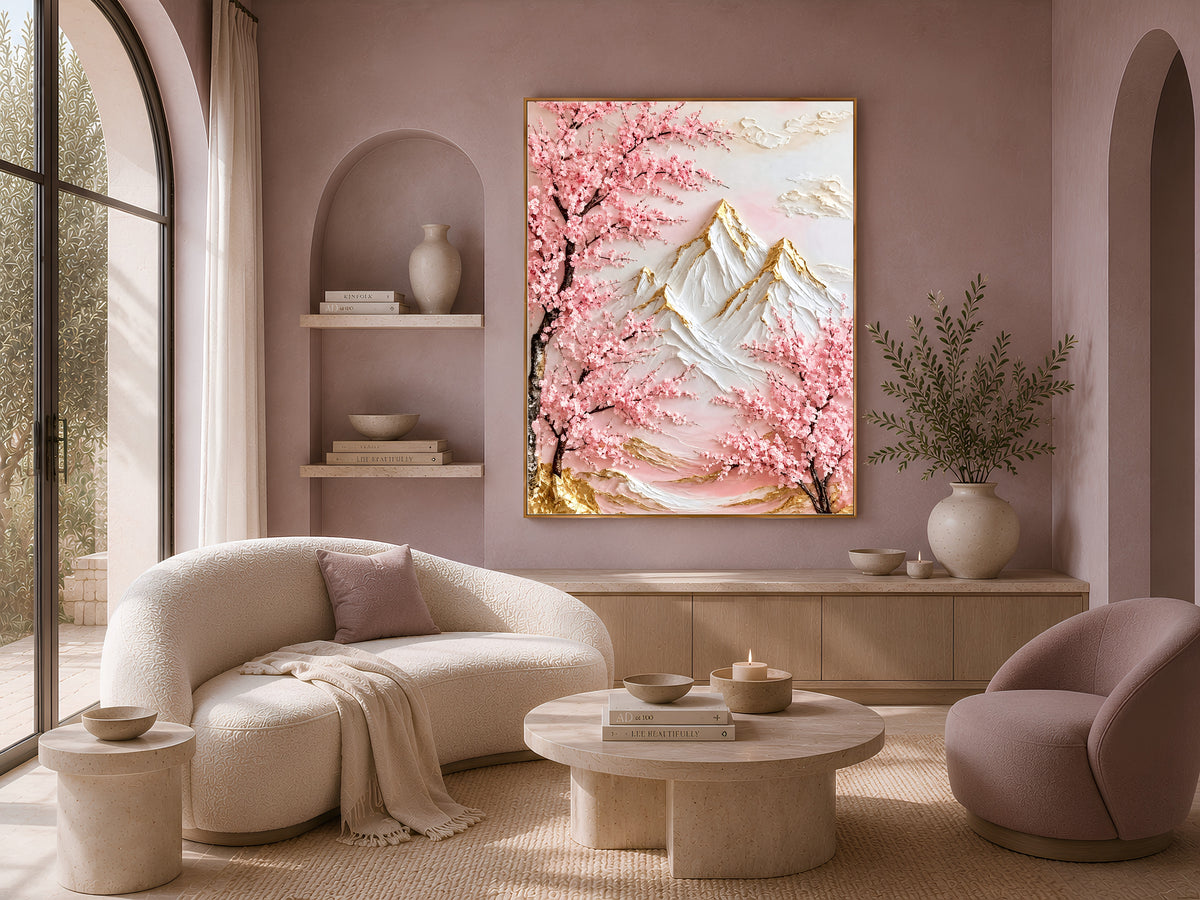 Framed cherry blossom mountain print above a cream curved sofa in a neutral living room with an arched wall niche