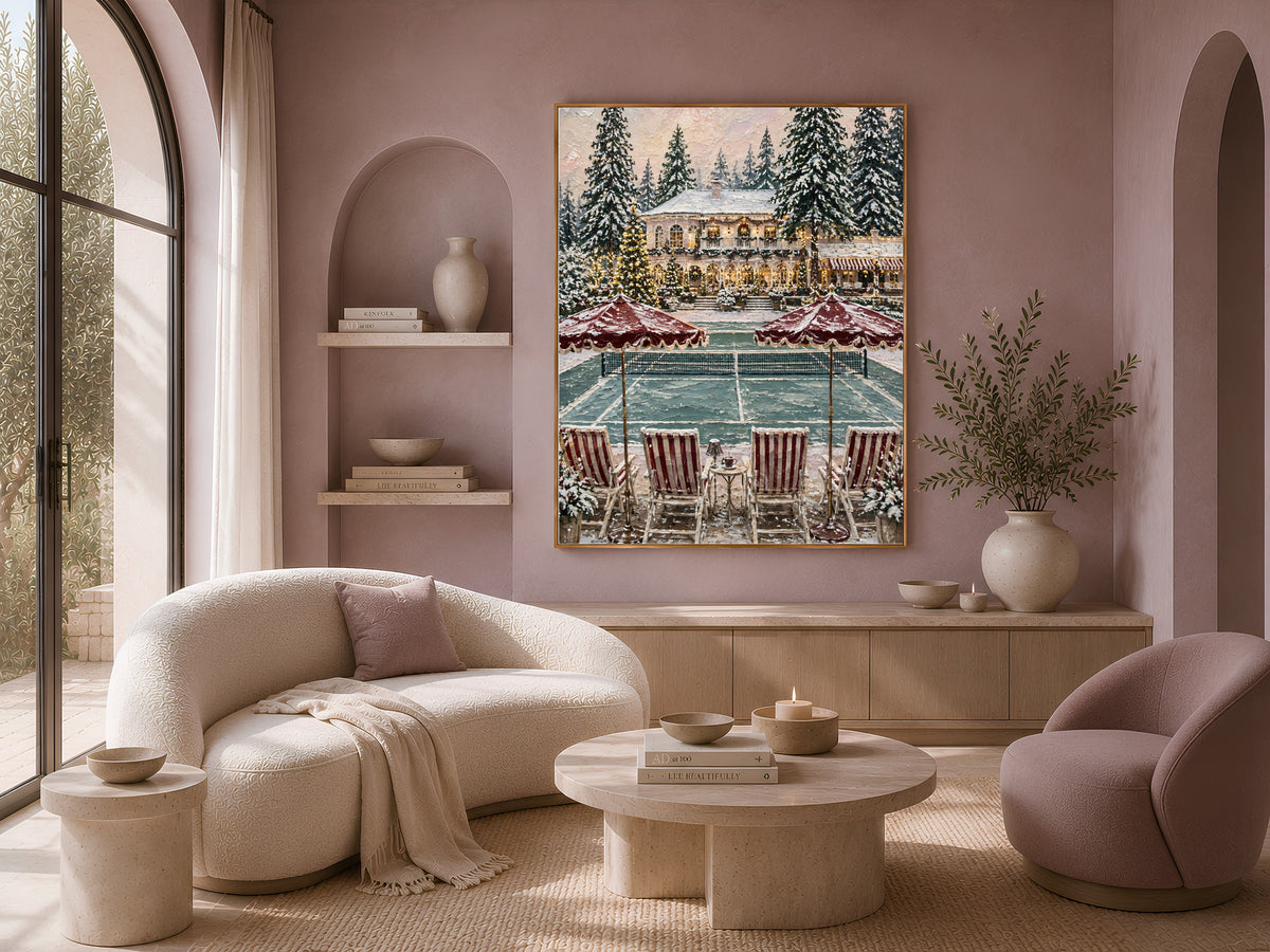 Winter mansion Christmas print framed above a curved boucle sofa in a warm pink living room with arched walls