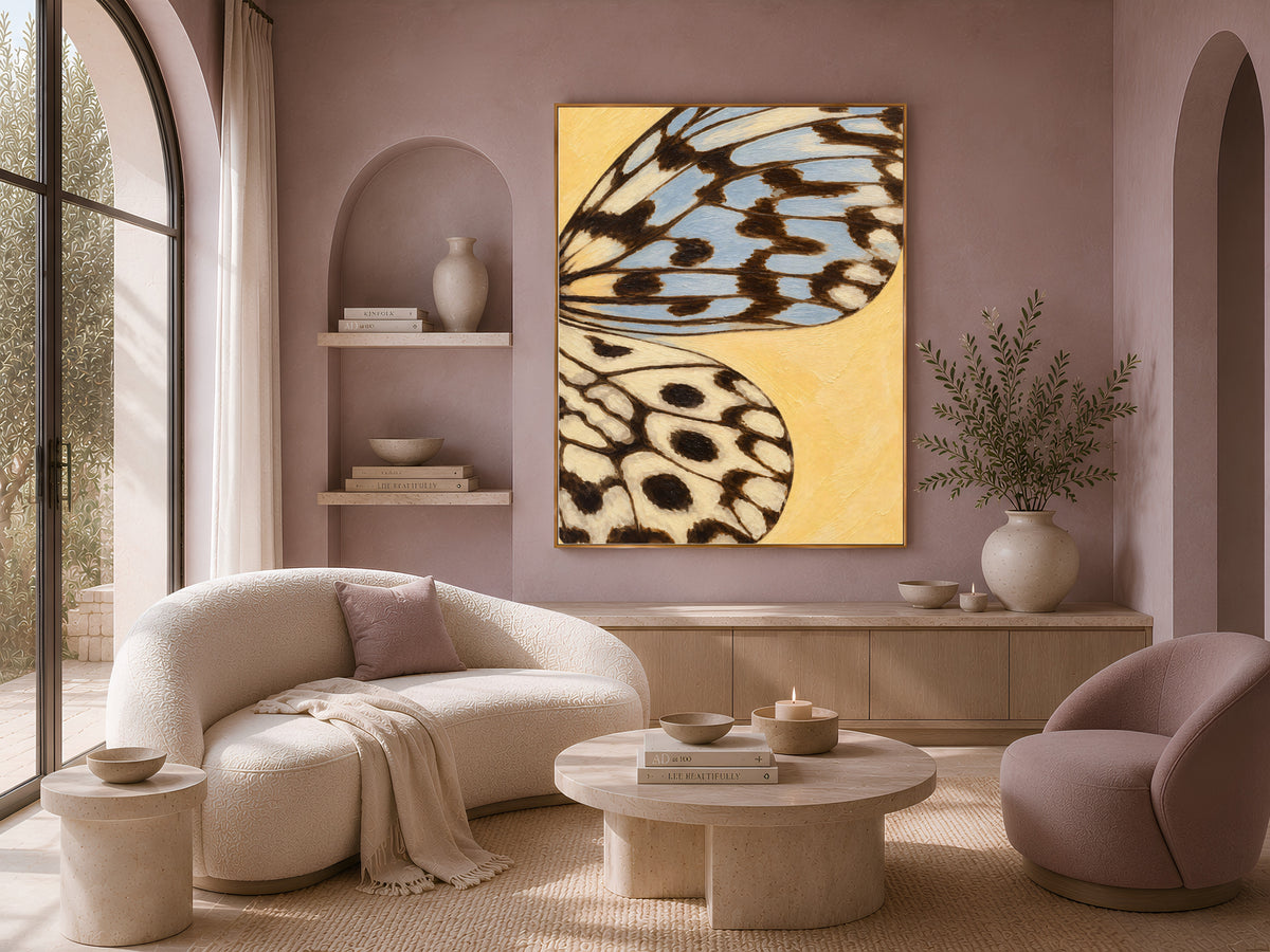 Butter yellow butterfly wing art framed on a mauve wall in a cozy curved-sofa living room