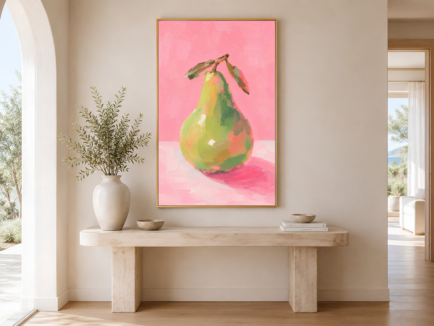 Framed impasto green pear print on warm white wall in minimal entryway with wooden console table and tall dried botanicals
