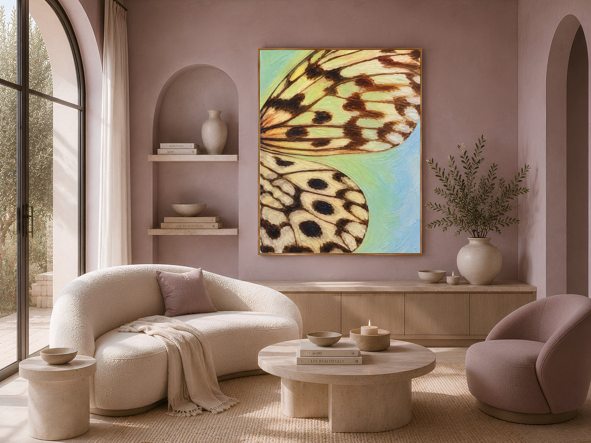 Teal gradient butterfly wing art framed on a mauve wall in a cozy curved-sofa living room