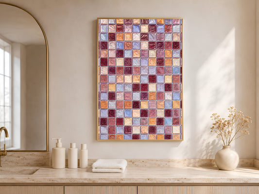 Mosaic tile wall art in a gold frame above a wood counter, styled with vases in front of an arched window.
