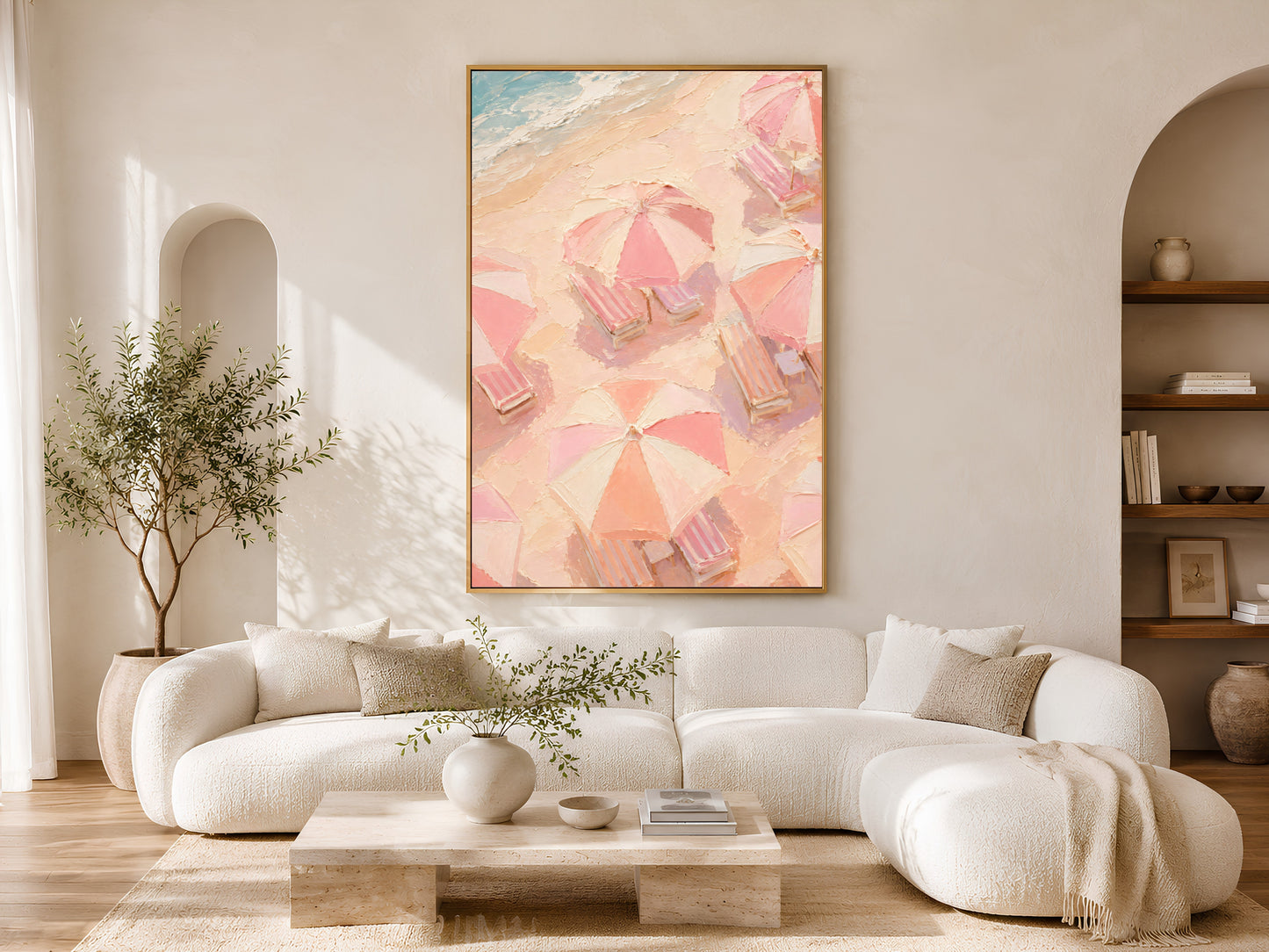 Pastel beach umbrella wall art in gold frame above a cream sofa in a bright neutral living room with arched shelving