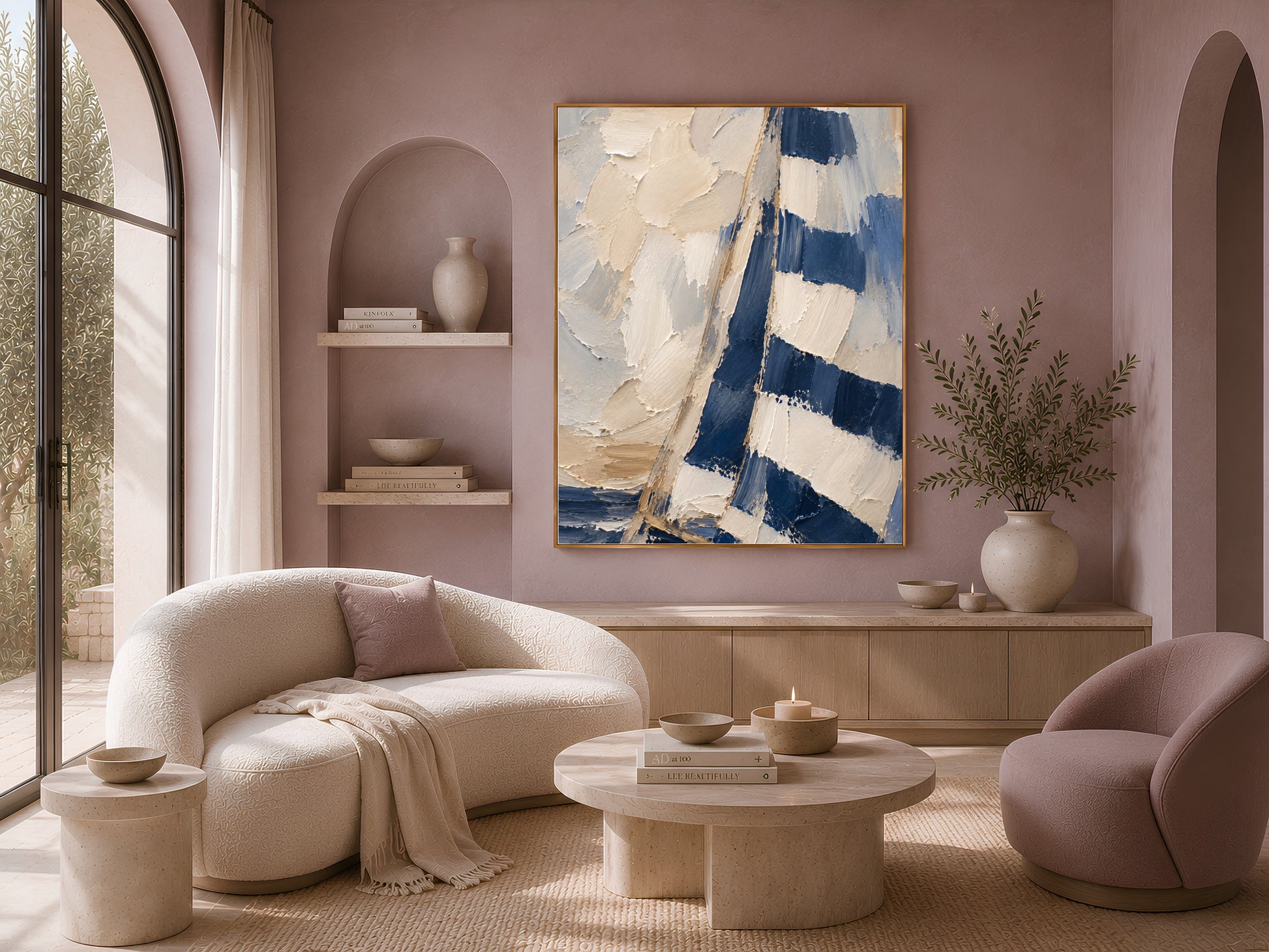 Navy sailboat wall art print displayed above a curved sofa in a sunlit living room