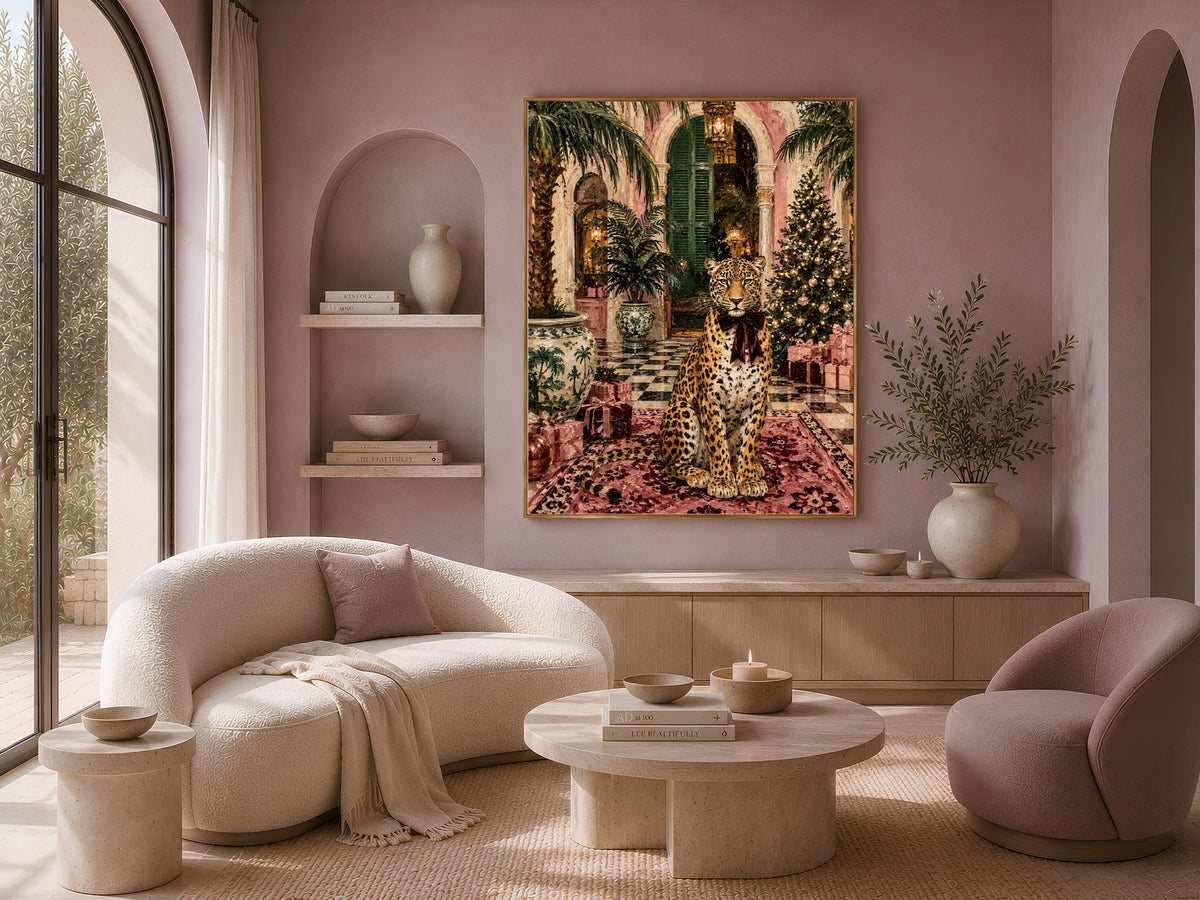 Leopard Christmas wall art framed above a curved boucle sofa in a warm neutral living room