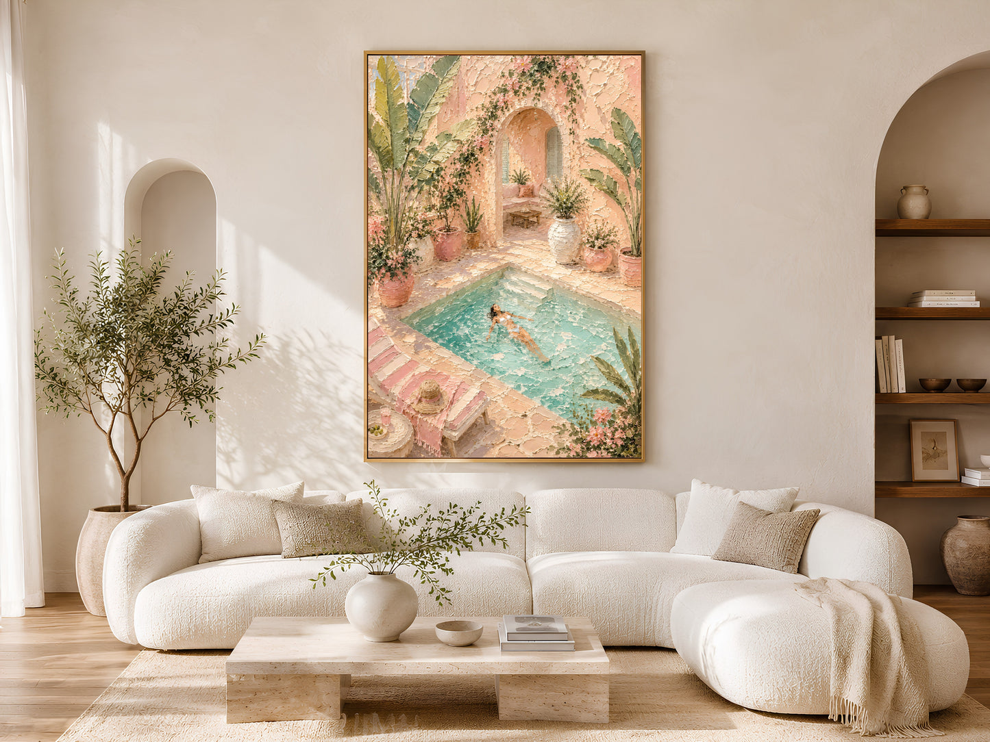 Framed pool villa impasto painting print in pink and green above a white curved sofa in a warm neutral living room with olive tree and coffee table
