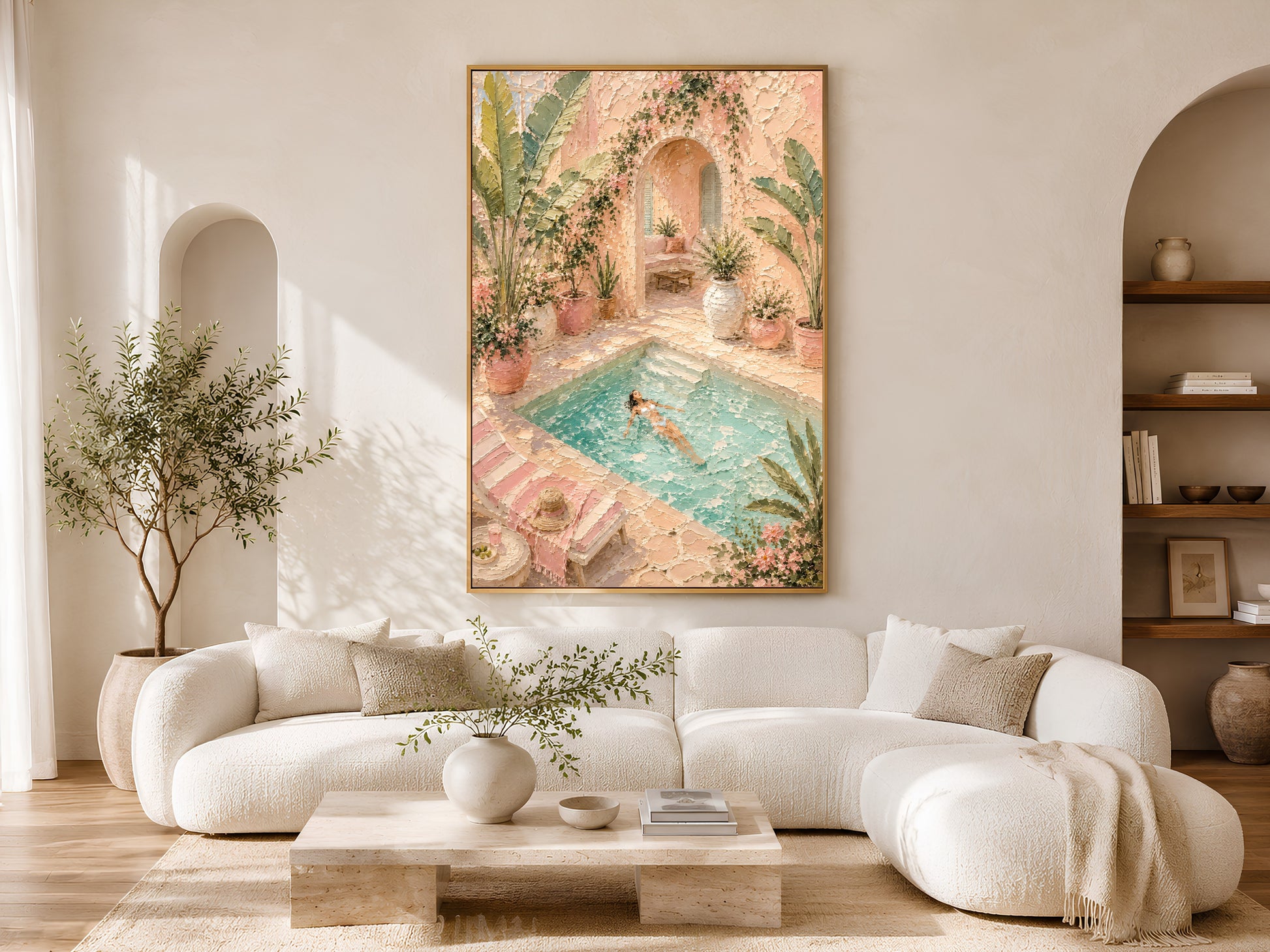 Framed pool villa impasto painting print in pink and green above a white curved sofa in a warm neutral living room with olive tree and coffee table
