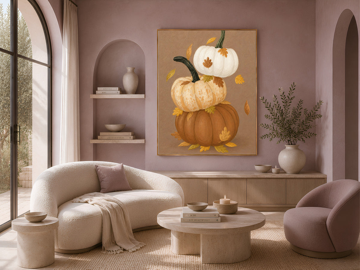 Stacked pumpkin wall art with autumn leaves above a boucle living room sofa