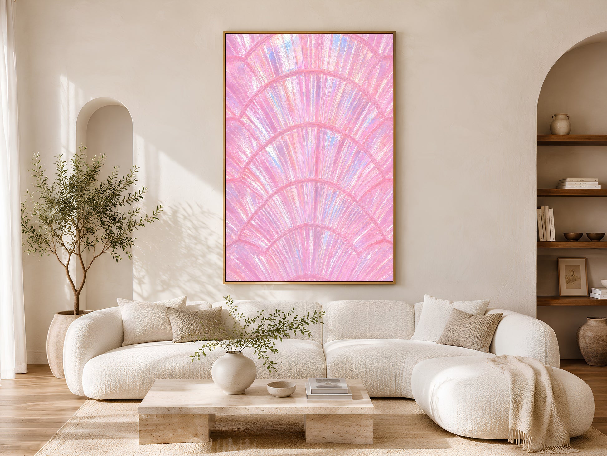 Iridescent pink shell print in gold frame displayed in a bright neutral living room with arched doorway and olive tree